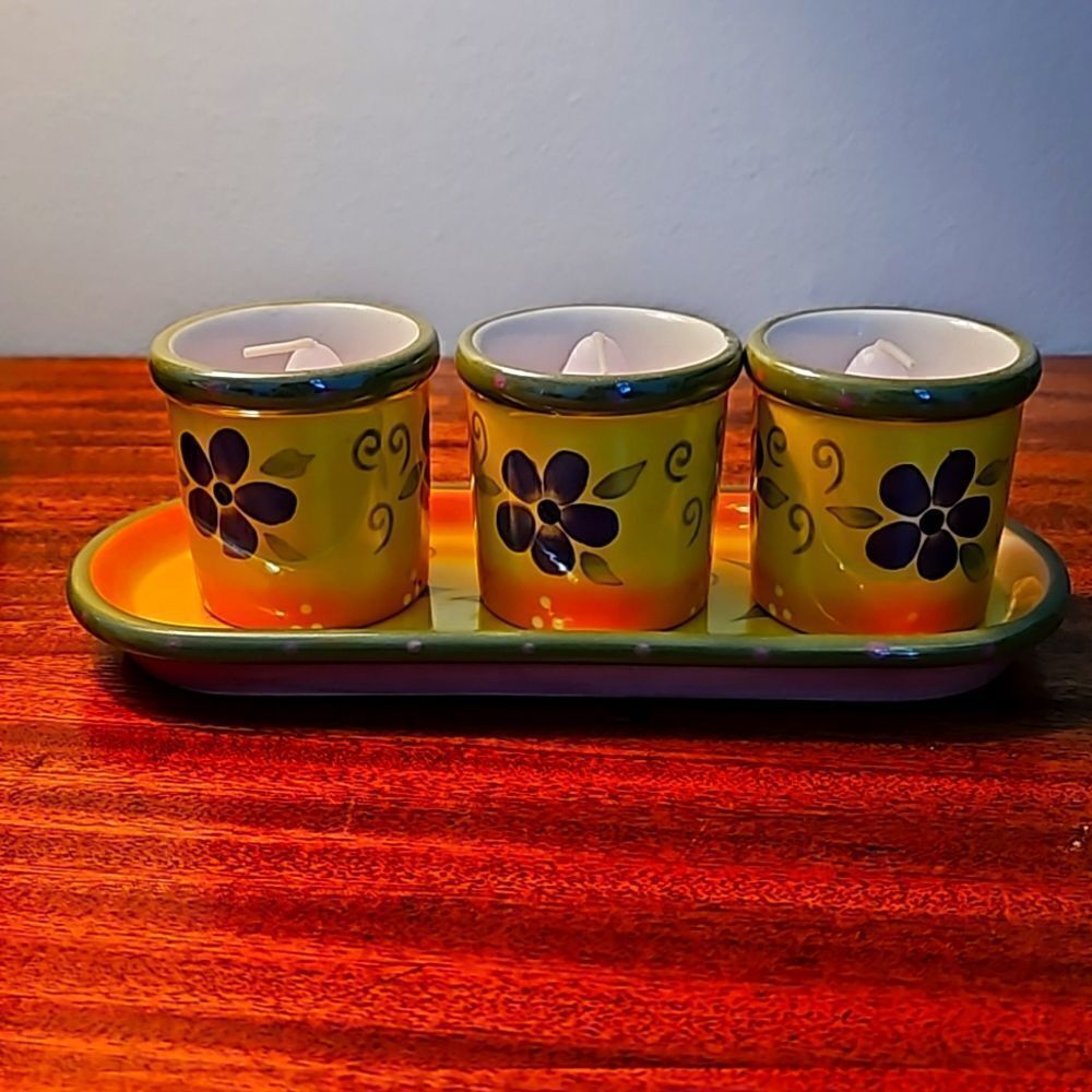 Partylite ceramic 4 piece candle holder set with candles.